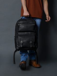 Indulge in timeless elegance with our NoirTrek Leather Backpack 2.0. Crafted in sophisticated black leather, this backpack effortlessly complements any outfit while providing ample storage. Its minimalist yet edgy design caters to the tastes of the youth, featuring clean lines and a contemporary silhouette. The backpack boasts a streamlined profile that remains on-trend while maintaining a sense of timelessness. The carefully chosen details, such as the silver zipper and snap closures gives it, Luxury Leather Commuting Backpack, Classic Black Leather Backpack For On-the-go, Modern Black Leather Backpack With Zipper Pocket, Classic Black Leather Backpack For Everyday Use, Black Leather Backpack With Leather Lining For Business, Classic Black Leather Satchel Backpack, Classic Black Rectangular Leather Backpack, Black Leather-lined Business Backpack, Classic Leather Backpack With Adjustable Strap For Commuting