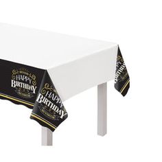 a black and white happy birthday table cover