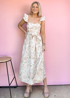 This is THE summer event midi. The lightweight fabric has a floral design and the cutest boned bodice. A smocked back detail and adjustable spaghetti straps on the back create a customizable fit. Style with nude heels for your next summer event, bridal shower, or date night. True to size Model is wearing small Size up if between sizes Color: White background with multicolor print Printed woven midi dress Adjustable straps Smocked back bodice Fabric has no stretch Not lined Summer Midi Dress With Sweetheart Neckline For Brunch, Summer Midi Dress With Sweetheart Neckline For Garden Party, Summer Midi Dress With Fitted Bodice For Brunch, Summer Midi Dress With Fitted Bodice For Date Night, Feminine Fitted Bodice Maxi Dress For Summer, Spring Midi Dress With Sweetheart Neckline For Brunch, Spring Midi Dress With Sweetheart Neckline And Adjustable Straps, Flirty Spring Maxi Dress With Sweetheart Neckline, Feminine Midi Dress For Garden Party