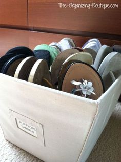 a white basket filled with lots of different types of hats