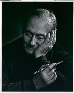 black and white photograph of a man holding a pen