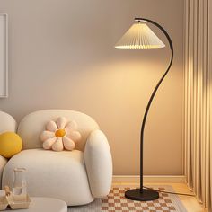 a living room scene with focus on the floor lamp and white chair, which has a flower shaped pillow on it