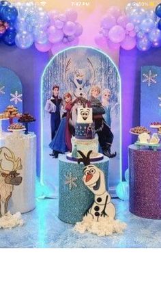 a frozen princess themed birthday party with balloons and cake stands, all decorated in different colors