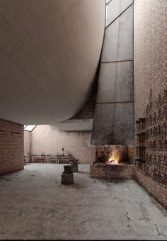 an empty room with brick walls and a fire place in the center that is lit up