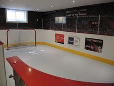 an indoor hockey rink with red and yellow lines on the ice, surrounded by black walls