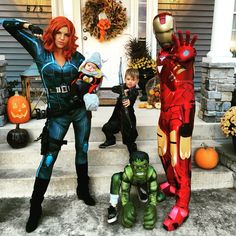 a woman and two children dressed up as iron man, spider - man, and hulkman