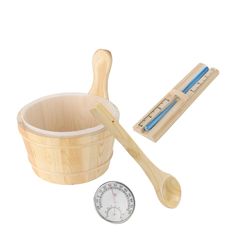 a wooden measuring cup and spoon next to a thermometer