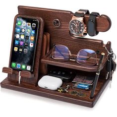 an iphone and glasses are in a wooden case with other items on the shelf next to it