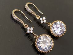 Crystal Cubic Zirconia Gold Chandelier Dangle Bridal Wedding Earrings. EARRINGS are about 1.49 inch (3.8cm) long from top of ear wire to bottom. BRIDAL EARRINGS SECTION: https://www.etsy.com/shop/LanaChayka?ref=seller-platform-mcnav§ion_id=11638940 BRIDAL JEWELRY SETS SECTION: https://www.etsy.com/shop/LanaChayka?ref=seller-platform-mcnav§ion_id=25839214 BRIDAL NECKLACES SECTION: https://www.etsy.com/shop/LanaChayka?ref=seller-platform-mcnav§ion_id=11638944 Elegant and timeless, these gorgeous e Gold Round Crystal Earrings For Wedding, Round Crystal Earrings For Wedding, Cubic Zirconia Chandelier Earrings For Wedding, Round Cubic Zirconia Crystal Earrings For Wedding, Round Bridal Earrings With Diamond Accents, Diamond White Round Bridal Earrings For Wedding, Diamond White Round Bridal Earrings, Round Crystal Earrings With Prong Setting For Wedding, Wedding Crystal Dangle Earrings With Prong Setting