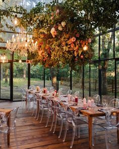 an outdoor dining area with chandelier and tables set up for a formal function