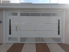 a white garage door with shutters on the side