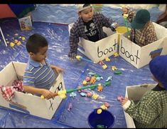 children playing with boats made out of cardboard