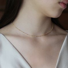 "PERFECT CHRISTMAS GIFT /WEDDING GIFT FOR BRIDE / BRIDESMAID / LADY! This original rhodium plated satellite chain necklace measures 15.5\" (39cm) long with 2\" (5cm) extender chain. The distance between beads is 1/2\" (1.2cm). This chain is so versatile and would be perfect for layering. The beads add an elegant touch and a delicate sparkle to any outfit! Other necklace shown layered on the model are available separately in my shop: https://www.etsy.com/listing/681912516/swarovski-crystal-circle Elegant Beaded Chain Choker For Weddings, Elegant Wedding Choker With Beaded Chain, Elegant Adjustable Christmas Necklaces, Elegant Christmas Adjustable Necklace, Gold Choker With Tiny Beads For Parties, Dainty Gold Choker For Wedding, Elegant Beaded Christmas Necklaces, Elegant Christmas Beaded Necklaces, Horn Necklace Boho