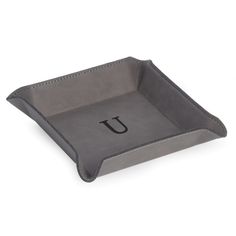 a gray tray with the letter l on it and a black initial in the middle