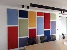 an empty conference room with colorful panels on the wall