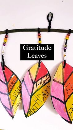 two pieces of paper hanging from a clothes line with the words, grateful leaves written on them