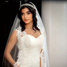 a woman wearing a wedding dress and veil