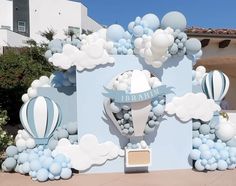 an outdoor display with balloons and clouds