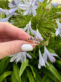 Vintage 9k Swirl Ring Stacker (Natural Amethyst, Garnet, and Iolite) Description: This vintage 9k swirl ring stacker features natural amethyst, garnet, and iolite stones, making it a unique and trendy addition to your jewelry collection. Sized at 5 3/4 (almost a 6) and weighing 2.02g, this ring showcases English hallmarks and is perfect for stacking and creating a personalized look. As with all our pieces, this ring is a rare find—once it's gone, it's gone. Choosing this piece helps you stand ou Heirloom Multi-stone Amethyst Ring, 14k Gold Multi-stone Amethyst Promise Ring, Purple Multi-stone Amethyst Ring Fine Jewelry, Heirloom Multi-stone Amethyst Ring In 14k Gold, Classic Multi-stone Amethyst Ring In 14k Gold, Antique Gold Amethyst Multi-stone Ring, 14k Gold Multi-stone Amethyst Ring, Vintage 14k Gold Multi-stone Amethyst Ring, 14k Gold Multi-stone Purple Amethyst Ring