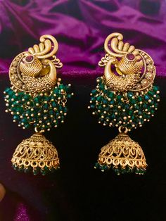 Add elegance to your Indian outfit with our Antique Peacock Earrings, available in 4 different colors. Crafted with intricate details, these earrings are a timeless addition to your jewelry collection. Elevate your style with the beauty of these stunning earrings. Length - 7 cm Jewellery Care- Keep the jewelry dry, avoid heat and contact with perfumes & water. Jhumkas Gold, Beautiful Gold Earrings, Gold Jhumka, Gold Jhumka Earrings, Peacock Earrings, Bridal Choker, Fancy Blouses, Jhumka Earrings, Indian Outfit