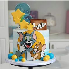 a birthday cake with an image of tom and jerry on it