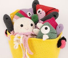 a crocheted basket filled with stuffed animals