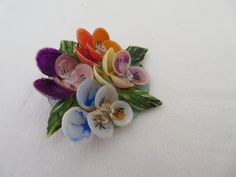 "A vintage shell flower brooch dating from the 1960's. Beautiful dyed and painted shells put together to make flowers that remind me of pansies. In shades of purple, lilac, orange, yellow, blue and green It measures approx 2\" diamter (at widest points). It has a silver tone pin which fastens into a roll over clasp In excellent vintage condition with minimal chips to a few of the petals which can only be seen under a jewellery glass Postage in the UK is by Royal Mail First Class Signed For servi Seashell Painting, Painted Shells, Shawl Pins, 3d Flowers, Flower Brooch, Vintage Art Deco, Shades Of Purple, Bridal Portraits, Flower Making