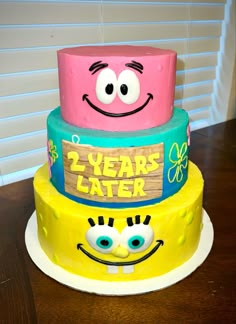 two tiered cake decorated to look like spongebob faces and the words 2 - year later