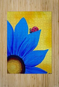 a jigsaw puzzle with a lady bug on top of a large blue flower