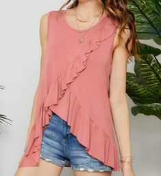 SO. SO. SO CUTE! You'll love everything about this ruffle tank. So comfortable and trendy you'll want to wear it over and over again. This mauve ruffle tank looks great with white skinnies and your favorite jean shorts. Features a round neck and a ruffled asymmetrical hem. Made in USA 96% Rayon 4% Spandex Young Adult Fashion, White Skinnies, White Corset Top, Our Love Story, Sparkly Top, White Chic, Ruffle Tank Top, V Neck Tank Top, Tunic Tank Tops