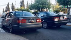 two cars parked next to each other on the street