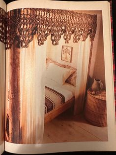 an open book showing a bed and curtains