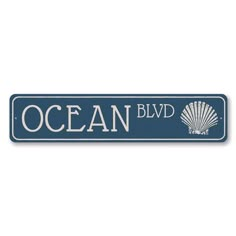 the ocean blvd sign is blue and white with an image of a shell on it