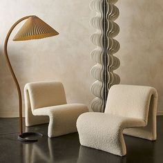 two chairs and a lamp in a room