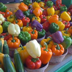 several baskets filled with different colored peppers