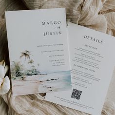 two wedding programs are laying on a bed next to a white flower and an envelope