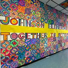 a large colorful mural on the side of a building that says, johnson elementary together is here