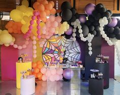 an assortment of balloons are on display at a party