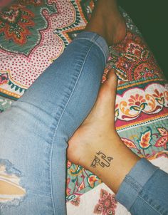 a woman's foot with the word yes tattooed on it