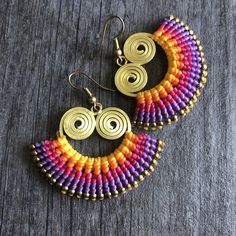 Unique fun multicolor macrame earrings. Made with brass wire, a mix of yellow, orange, violet, fuchsia and magenta brasilian wax cords, and small brass beads. All put together creating this unique fun bright pair that will rock your outfit. Perfect for your day by day outfits. The earrings are 3.2cm- 1.30 inch long 5cm- 2 inch wide Drop length of 4.6cm- 1.90 inch They are super light what makes them easy to wear. A unique addition to your jewelry collection Enjoy Con salud Adjustable Macrame Earrings For Jewelry Making, Adjustable Macrame Earrings, Multicolor Woven Adjustable Beaded Earrings, Adjustable Multicolor Woven Beaded Earrings, Handmade Bohemian Multicolor Wrap Earrings, Multicolor Macrame Earrings As Gift, Multicolor Woven Drop Earrings, Brasilian Wax, Multicolor Macrame