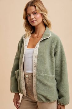 This Sherpa jacket is the perfect fall layer. The dreamy sage color is perfect for any outdoor adventure. Plus, it's reversible for ultimate versatility. Stay cozy and stylish amidst any outdoor adventure! Color: Mountain Sage + Ivory Two toned sherpa jacket Fully reversible Snap button closure One side plush sherpa and cotton nylon on the other Piped binding accents Pockets 100% polyester, Lining 65% cotton and 35% polyester Icon Clothing, Maxi Romper, Sage Color, Fall Layers, Reversible Jacket, Sherpa Jacket, Cardigan Top, Baby & Toddler Clothing, Stay Cozy