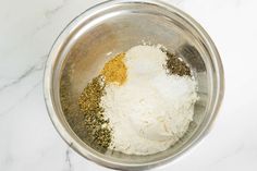 the ingredients are mixed together in a bowl on the counter top, including spices and seasoning