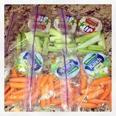 carrots and celery wrapped in plastic on a counter