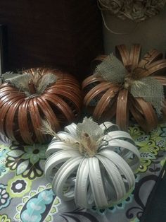 three decorative pumpkins sitting on top of a table