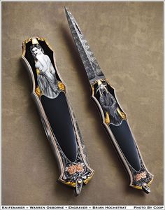 two knifes with designs on them sitting side by side next to each other,