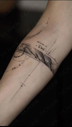 a person's arm with an abstract tattoo design on the left side of their arm