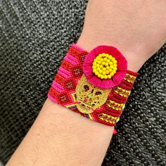 Bring the vibrant energy and handmade charm of Oaxaca, Mexico to your own wrist with our Woven Bracelet with Calaca Charm. This stunning piece combines the traditional techniques of Oaxacan weaving with the whimsy of boho-inspired fashion. Every bracelet is handwoven by skilled artisans in Oaxaca, using vibrant and durable threads that create intricate patterns and cheerful colors. The woven design adds texture and depth to the bracelet, allowing it to stand out from other accessories. The focal Adjustable Bohemian Friendship Bracelets, Bohemian Resizable Braided Bracelets For Friendship, Adjustable Woven Wrap Bracelet As Gift, Adjustable Woven Wrap Bracelet Gift, Multicolor Woven Bracelets For Beach, Bohemian Woven Beaded Friendship Bracelets, Bohemian Woven Bracelets For Beach, Bohemian Woven Beaded Bracelets For Friendship, Bohemian Macrame Bracelet