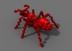 a red spider made out of legos on a gray surface with the legs extended