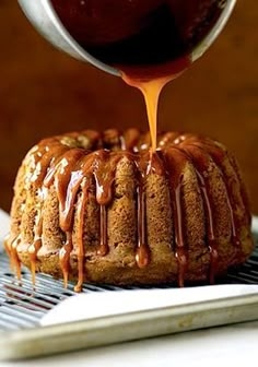 a bundt cake with caramel sauce being drizzled over it