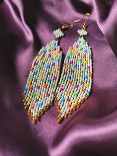 Design Drop Fringe Beaded Earrings with Colorful Confetti Dots.
They are elegant, fashionable and versatile, suitable for everyday wear, and for the holiday.
Developed a unique and inimitable design.
Made of high quality Japanese and Czech beads. (colors may vary due to your monitor settings).

Length - 10.5 centimeters
Width - 2.5 centimeters Seed Beads Earrings, Fringe Beaded Earrings, Sunflower Family, Beads Colors, Colorful Confetti, Earrings Patterns, Confetti Dots, Beaded Tassel Earrings, Earrings Colorful